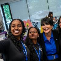 Group of Rep4 guests taking selfie with President Mantella